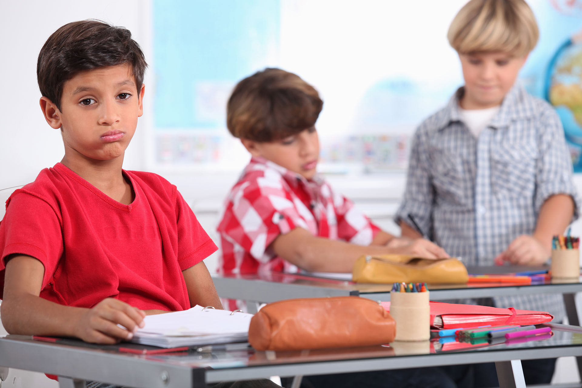 little boy sighing in a classroom