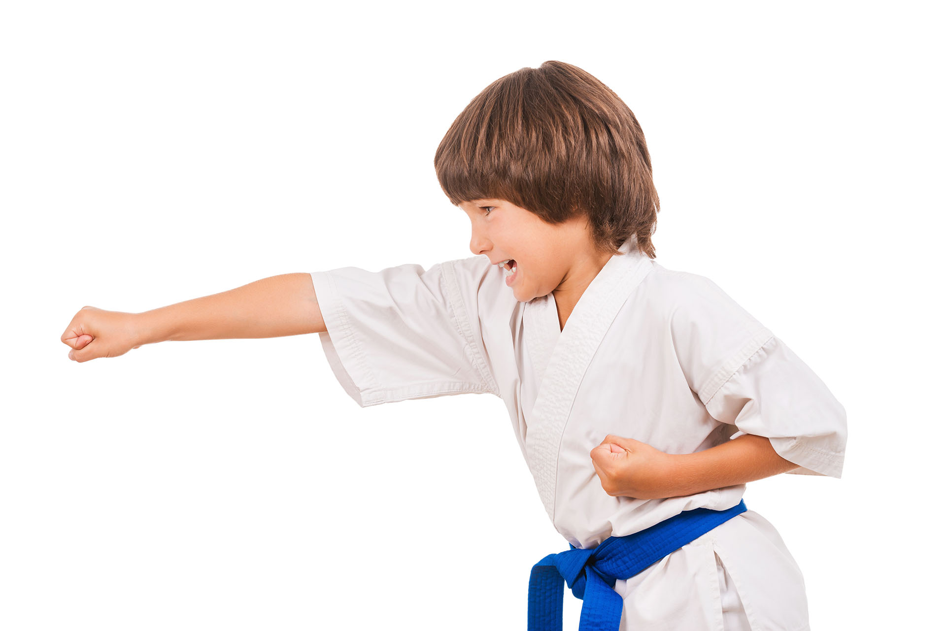Karate kid. Side view of little boy doing martial arts moves while isolated on white background